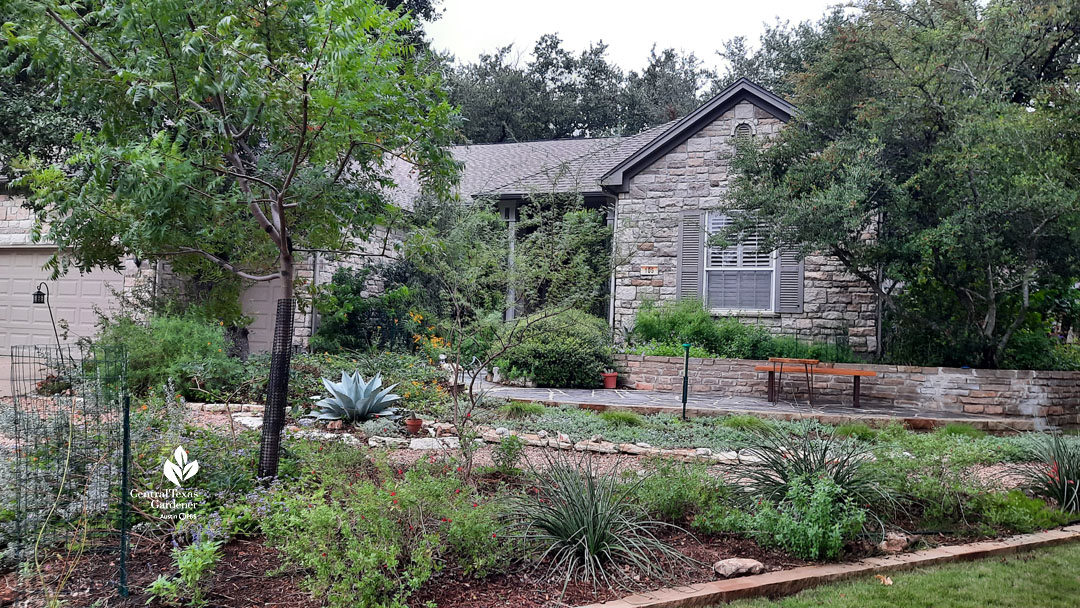 wide shot of multi-layered gardens in front of house