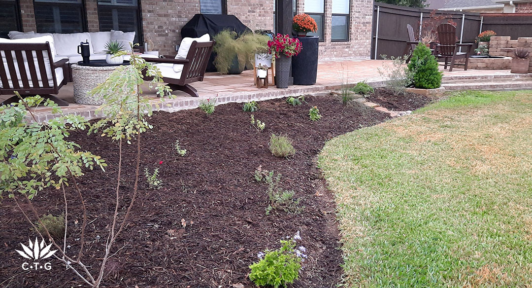 wide curved flower bed next to patio 