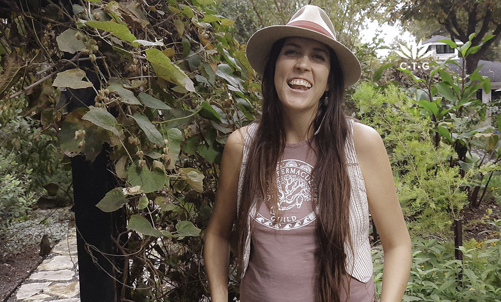 smiling woman in front of plants