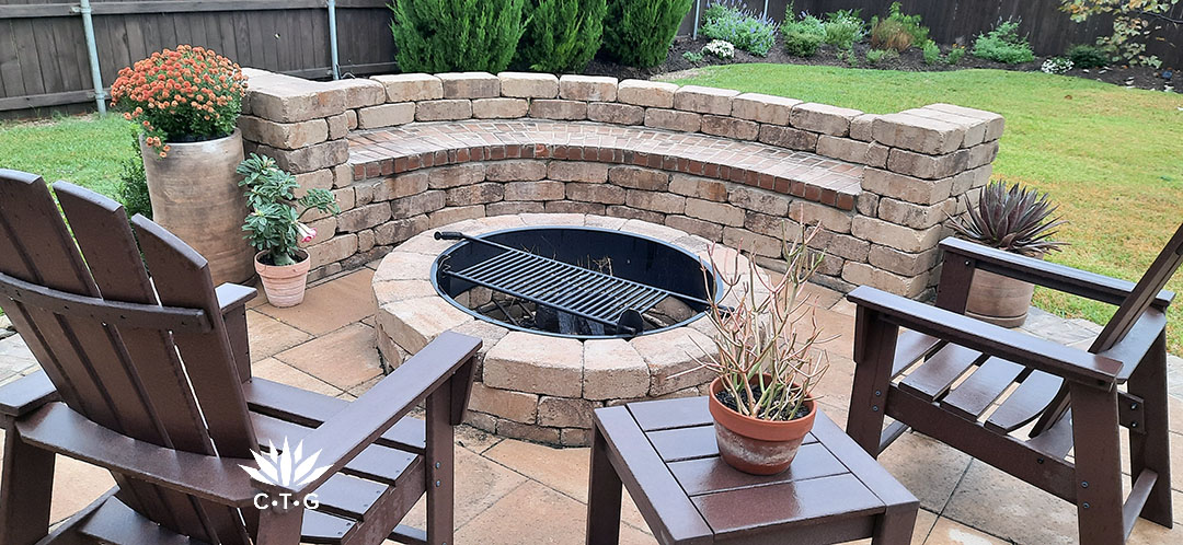 brick curved seating with concrete brick fire pit and casual lounge chairs 