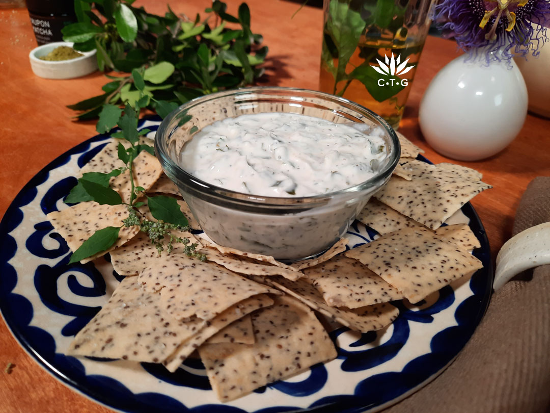 small bowl of dip on plate with crackers