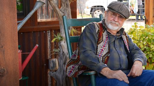 man with calm expression in rocking chair on porch