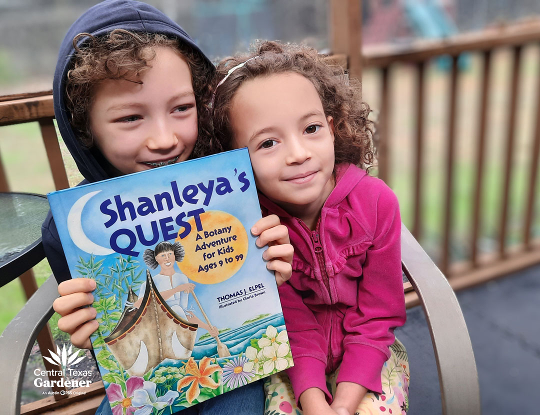 two children holding book called Shanaleya's QUEST 