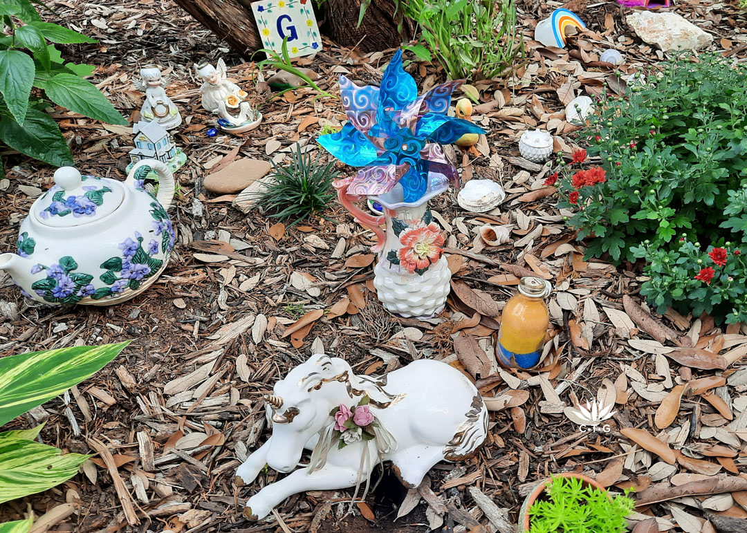 ceramic figurines and glass trinkets with ceramic tile and letter G