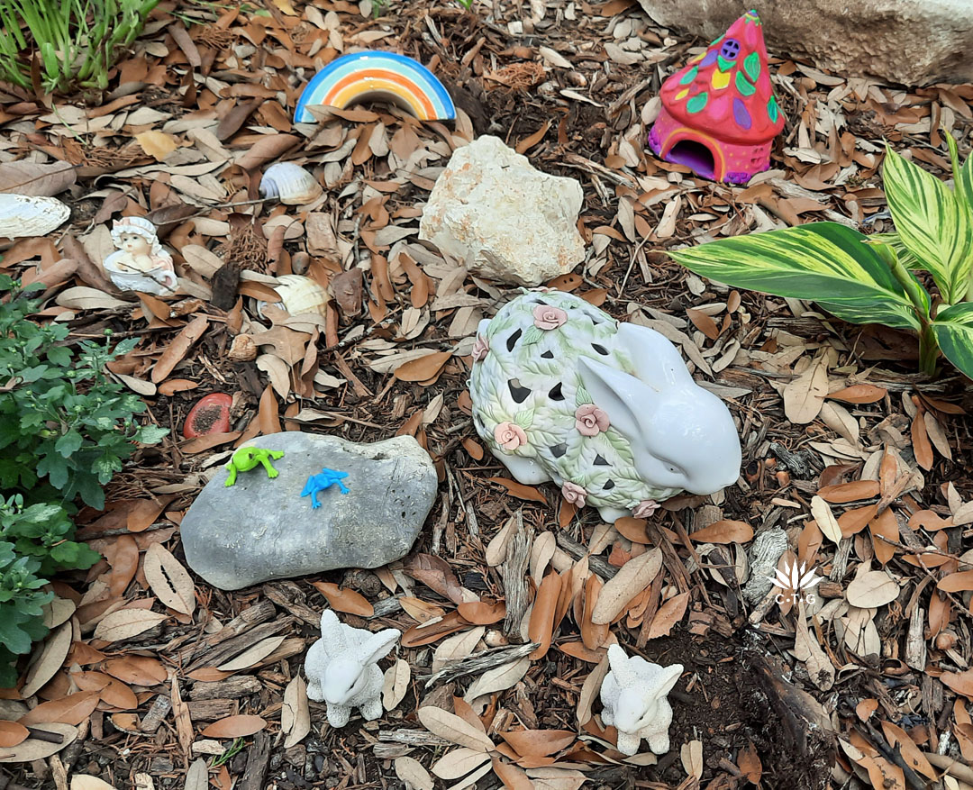 ceramic bunnies, painted rocks and garden art rainbow 