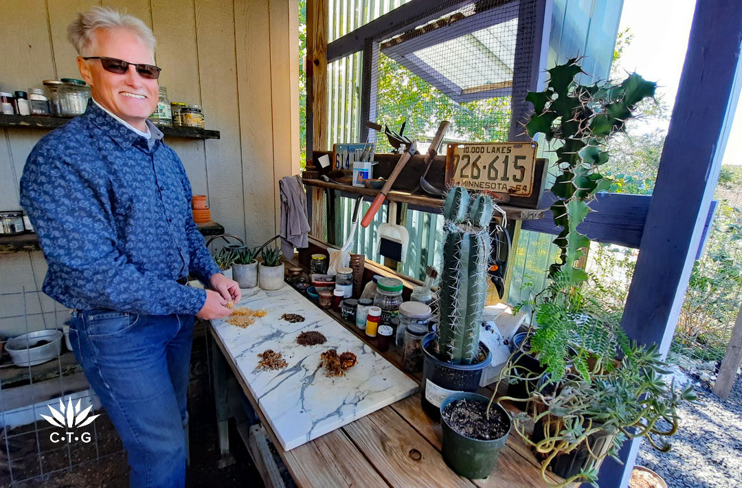 man separating seeds on a potting shed table 