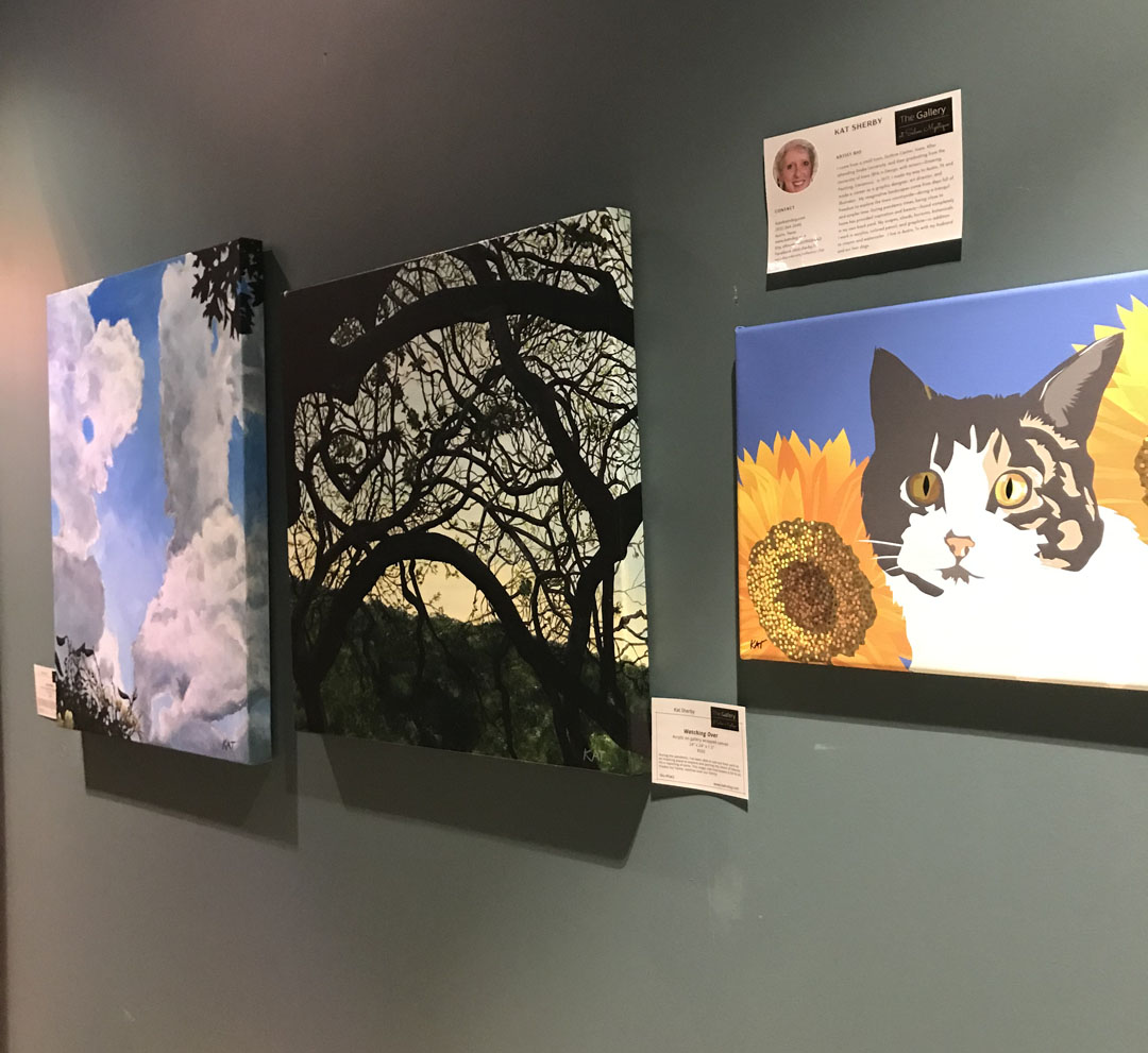 garden and animal paintings on a gallery wall