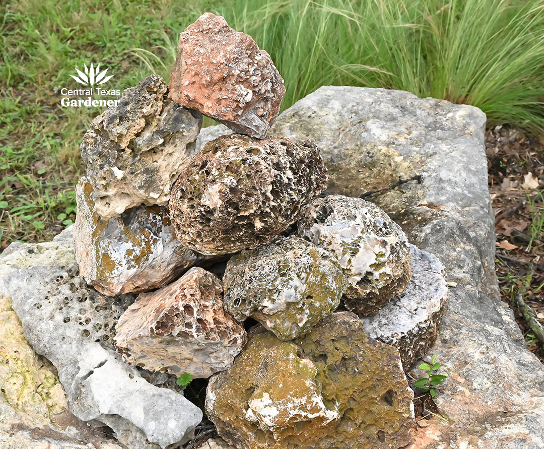 round, dimpled stones with other stones on top of a boulder