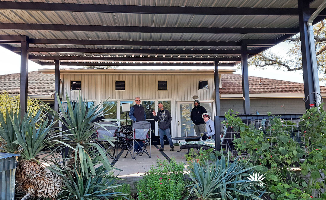 galvanized patio cover with 4 people smiling