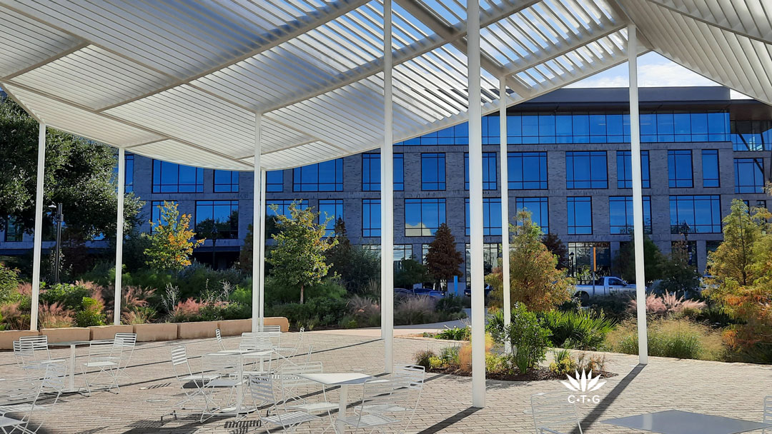 slat-roofed pavilion view to fall color on berms and in sponge (rain garden)