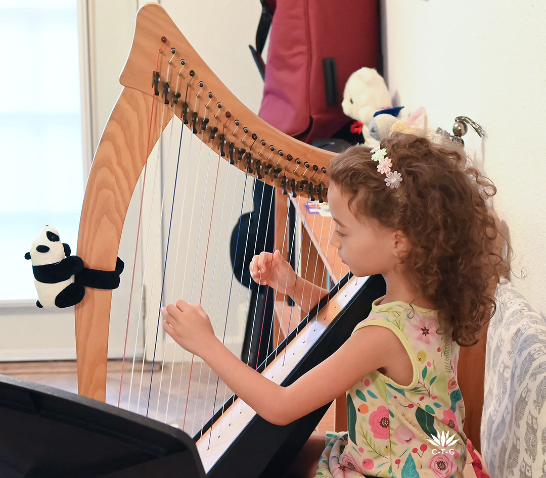 young girl playing harp