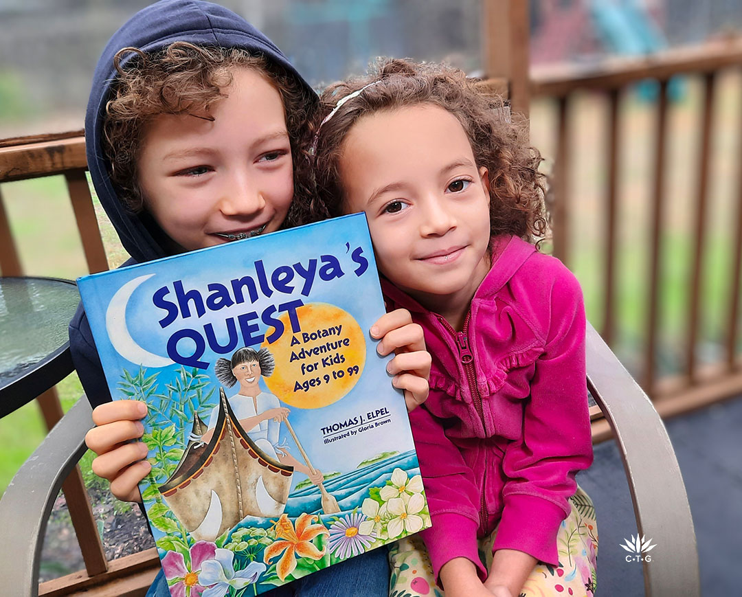 young boy and girl holding book Shanleya's Quest
